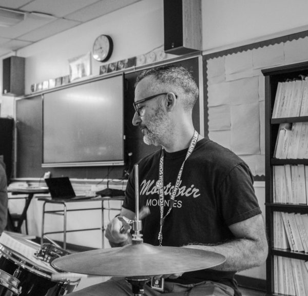 Credit: Jake Parker. Meyer plays on a drumset in the MHS music room. 